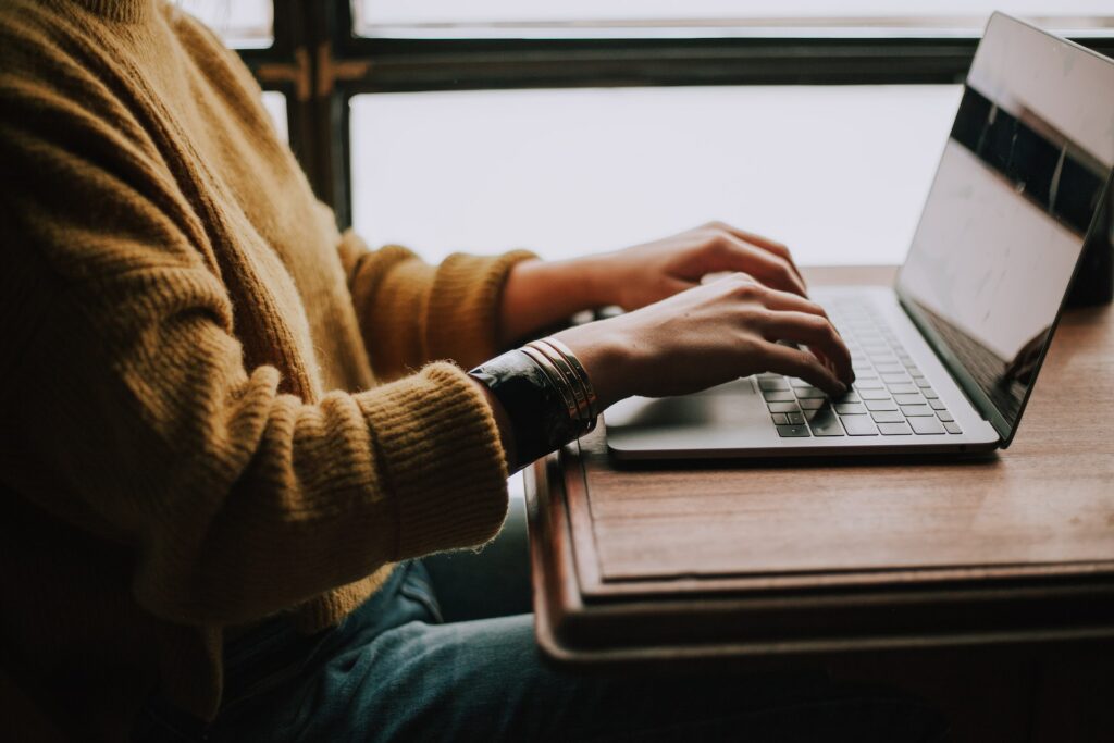 man typing on computer